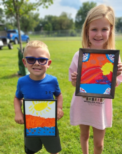 canvas painting two children holding a canvas they painted