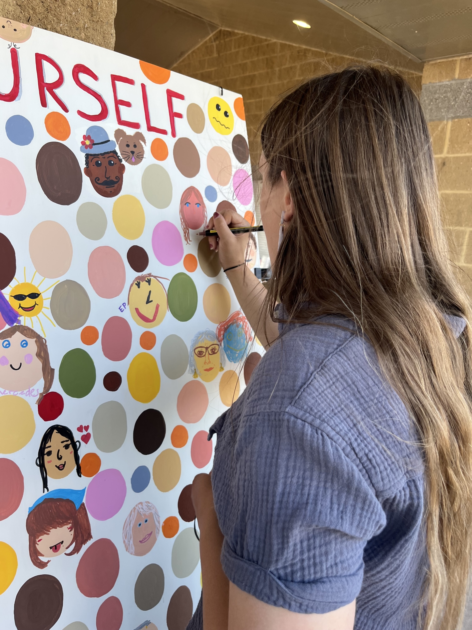 IMG_0990 girl drawing on the mural board